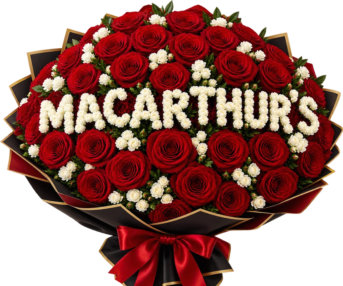 MacArthur's red rose bouquet with white baby roses spelling out MacArthur's, wrapped in black paper with a red ribbon